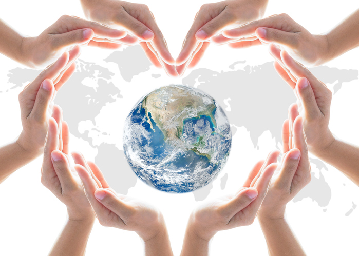 Hands connecting around earth globe